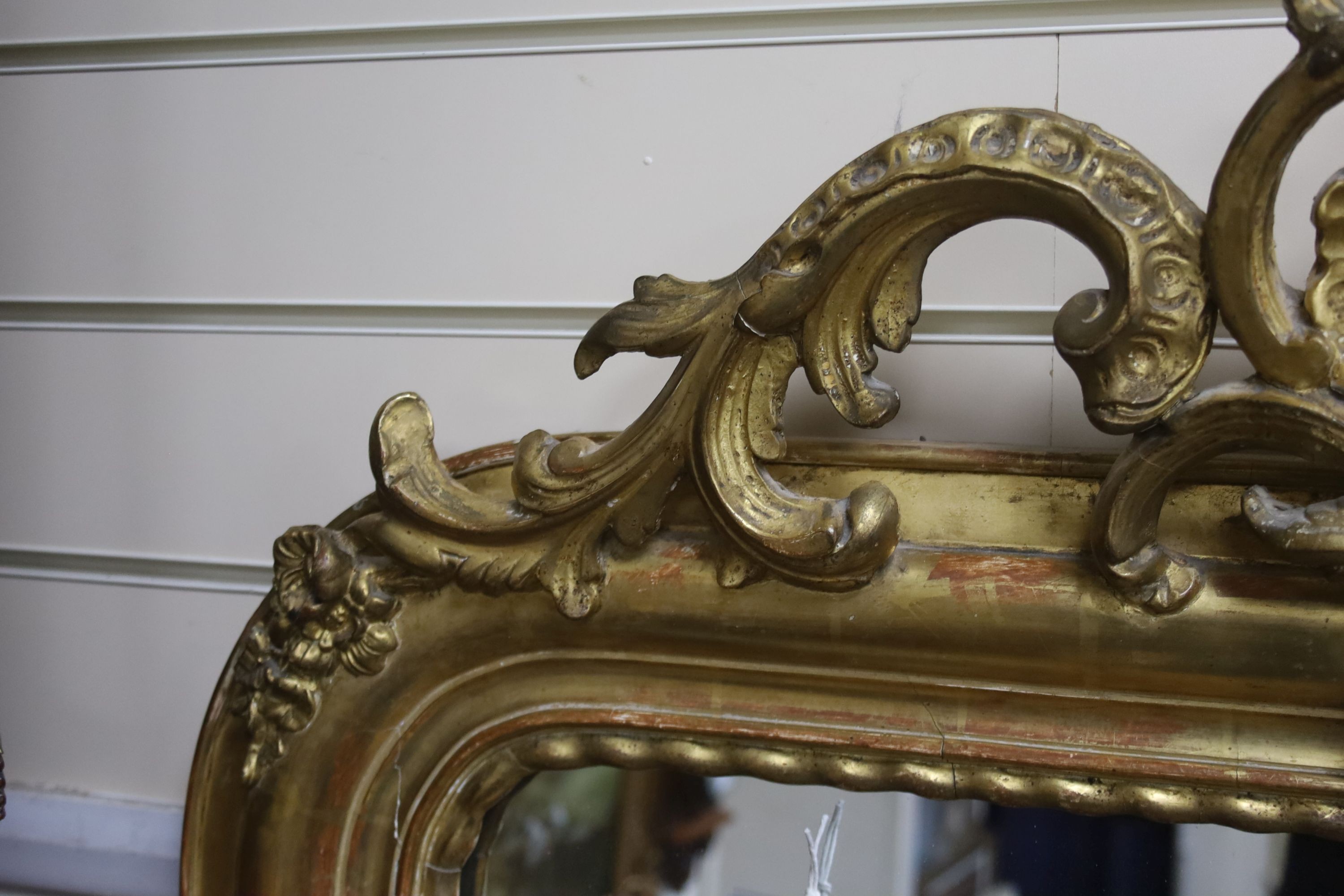 A 19th century French overmantel mirror, giltwood and gesso with channelled frame and scroll with cabochon crest detail, width 98cm, height 164cm